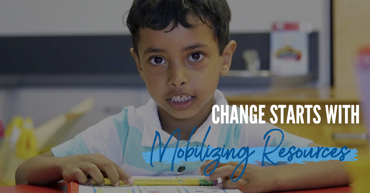 Picture of a little boy sitting at a desk in a classroom with the words Change Starts With Mobilizing Resources